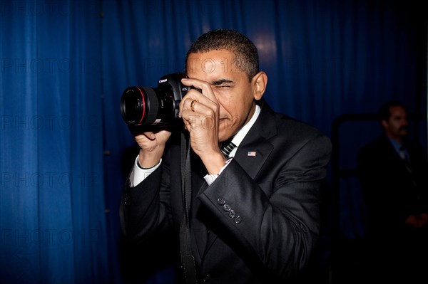 President Barack Obama takes aim with a photographer's camera backstage prior to remarks about providing mortgage payment relief for responsible homeowners. Dobson High School. Mesa, Arizona 2/18/09.  .