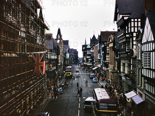 Buses and traffic on a street in Chester England circa July 1973.