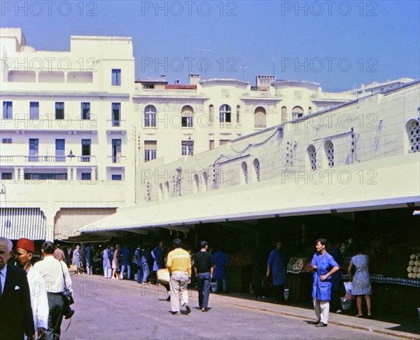 Vendors and customers at a food market in Casablanca Morocco circa 1969.