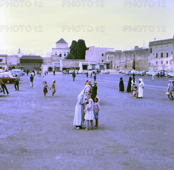 Veiled women talking to children in Rabat Morocco circa 1969.