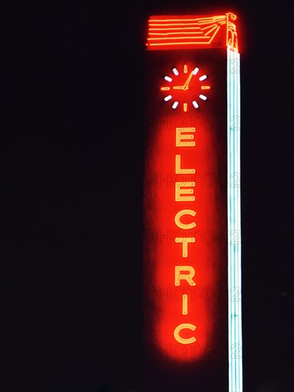 1956 Dallas - Neon sign featuring the word 'Electric' with a clock on top .