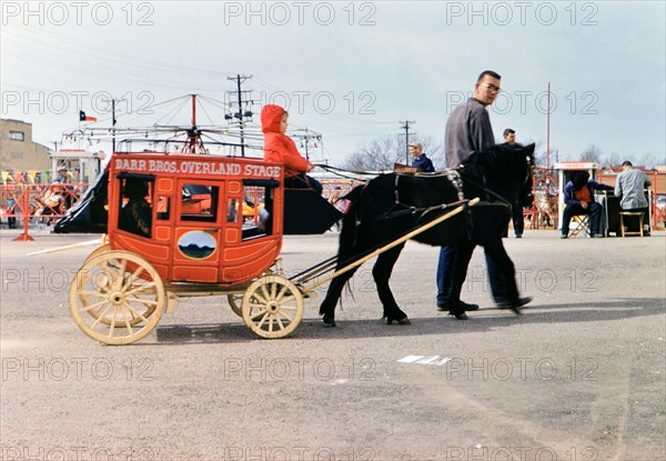 1960 Ft. Worth Stock Show - Little boy riding on a miniature stage coach at the stock show .