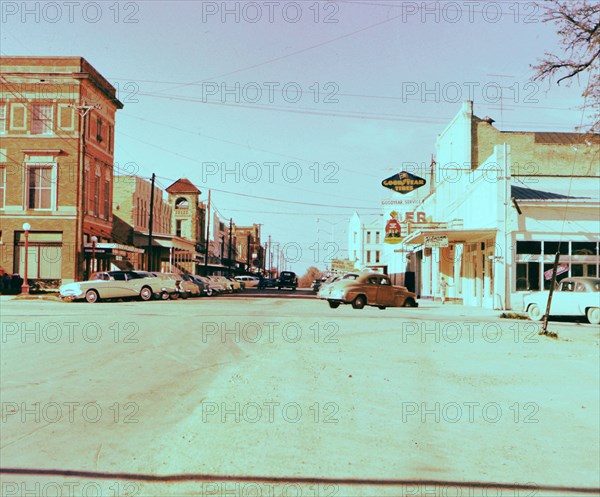 Cars parked on side of street in 1950s Lockhart Texas circa 1957.