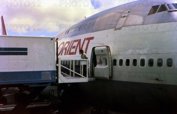 Skychef crew loading a Northwest Orient Airlines plane circa 1976.