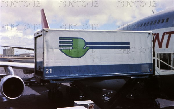 Skychef crew loading a Northwest Orient Airlines plane circa 1976.