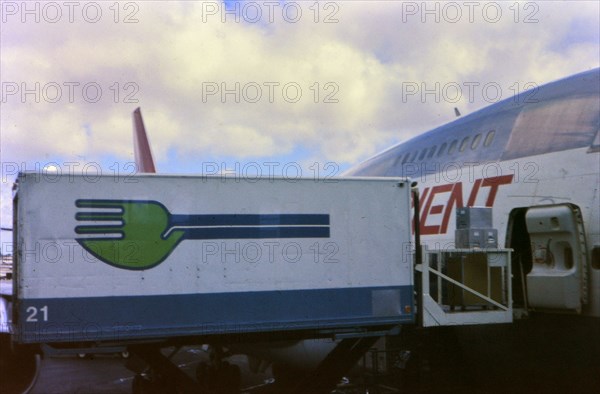 Skychef crew loading a Northwest Orient Airlines plane circa 1976.