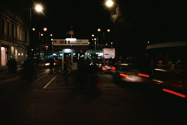 East Germans drive their vehicles through Checkpoint Charlie as they return to the East following a visit to the West..