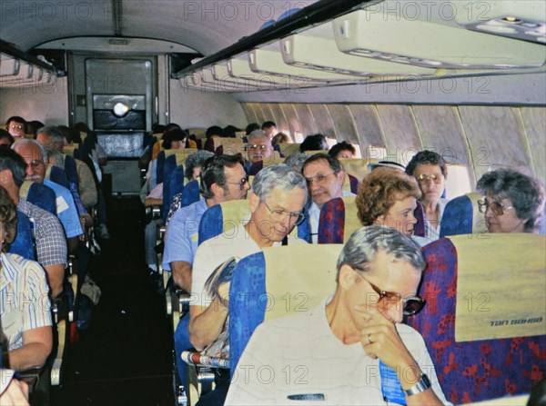 (R) Latin America / Honduras circa 1987 - Passengers onboard an airplane in late 1980s.