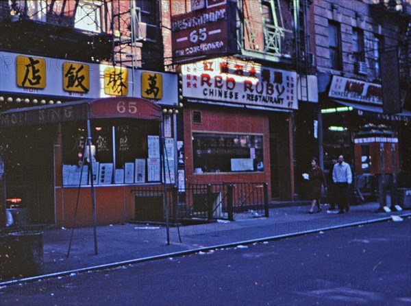 (R) New York 1975 - Red Ruby Chinese Restaurant and other businesses in the Chinatown area of New York City. Red Ruby became Big Wong Restaurant in 1978. This photo is Mott Street in Chinatown..