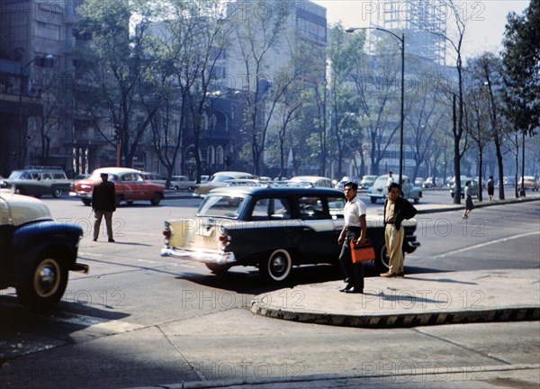 1962 Historical Photo -  Pedestrians and traffic in a large city (probably Mexico City or Guatemala City).