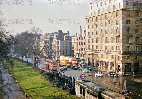 1961 London - Green Park Underground Station, double decker busses, city traffic.