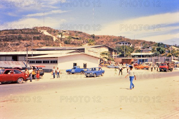 (R) Pedestrians at market in a Honduras village circa 1987.