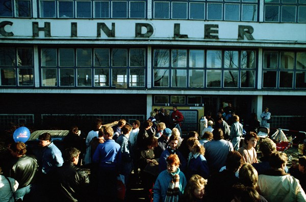 A crowd of East German refugees gathers outside the refugee center in West Berlin..