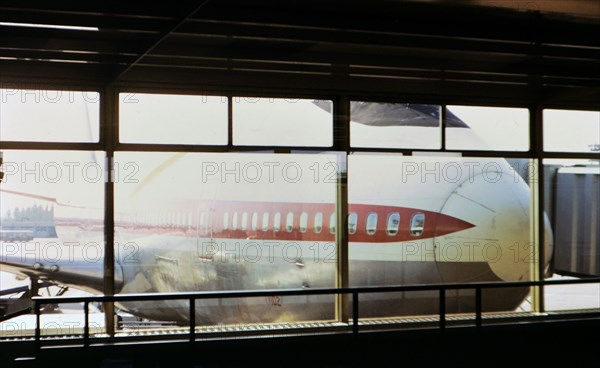 1972 France - (R) - Nose of a large airplane viewed through an airport terminal window circa 1972.