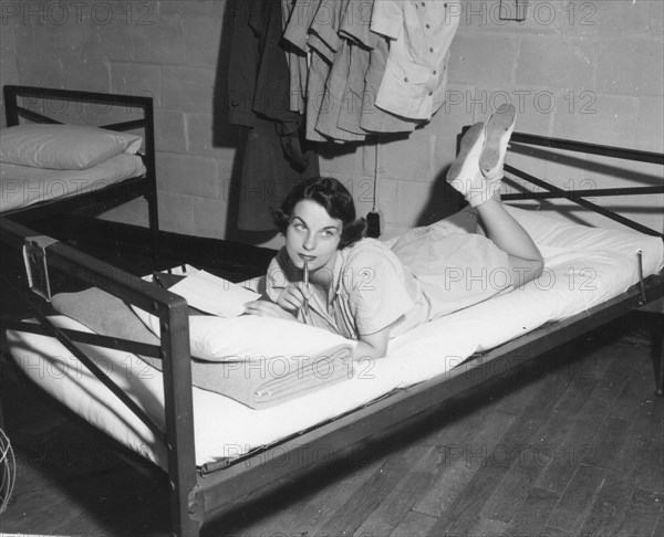 Female Marine writes letter in the barracks