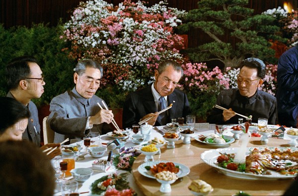 President Nixon using chopsticks