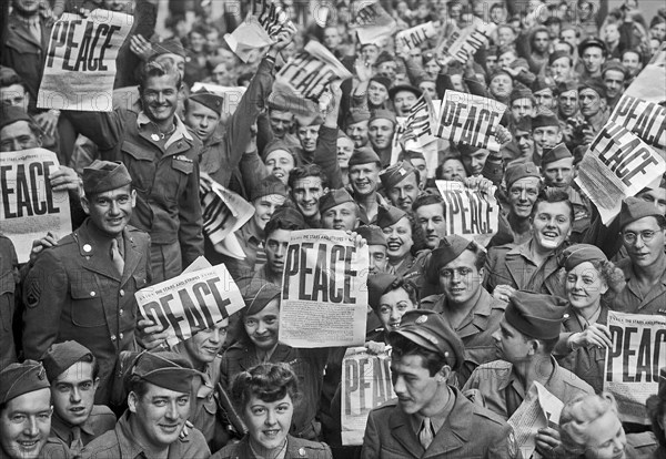 VE Day - Soldiers hold up the Stars and Stripes newspaper