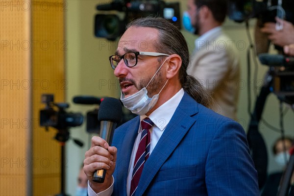 A reporter takes his mask off to ask a question as Secretary of State Mike Pompeo holds a joint press conference with Czech Prime Minister Andrej Babis