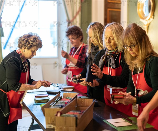 Volunteers prepare decorations for the Green Room of the White House Wednesday