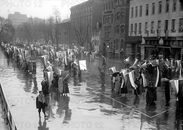 Woman suffragettes marching in the rain