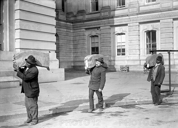 Workers carrying bags of franked mail at the U.S. Capitol