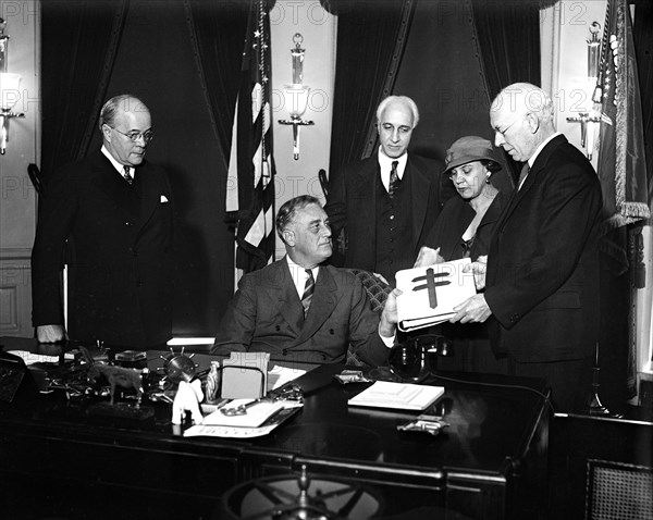 President Franklin Roosevelt is given a collection of rare Christmas Seals