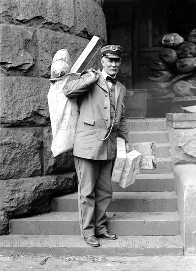 Mailman delivering parcel post packages