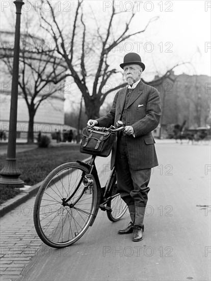 Old man standing next to his bicycle