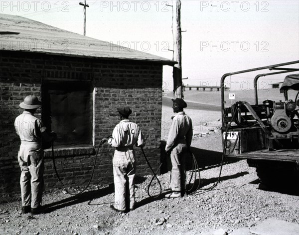 A malaria control detachment sprays billets at Amirabad Post