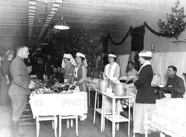 Red Cross nurses serving food to soldiers in hospital