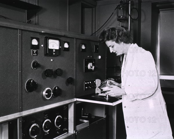 Female researcher loads material into an ultracentrifuge.
