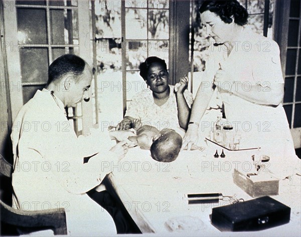 African American infant is getting an injection