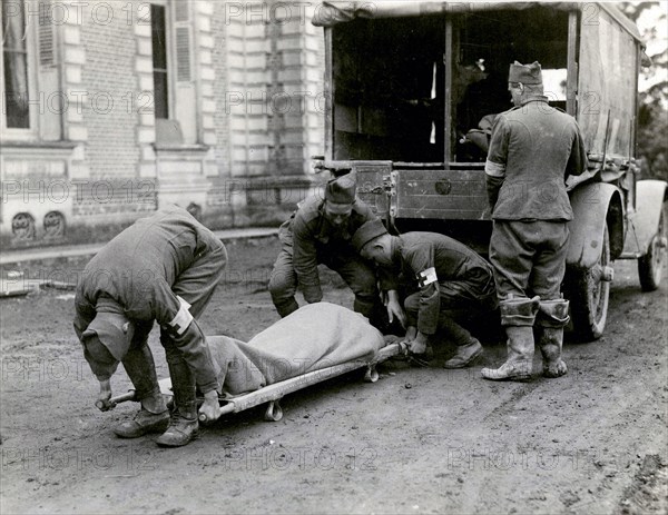 Moving a wounded man from an ambulance