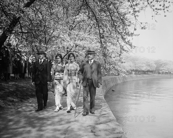 Japanese men and women and cherry blossoms