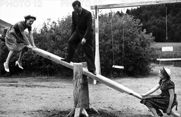 Girls playing on see saw or teeter totter in Germany