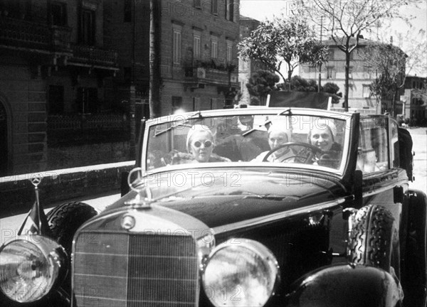 Woman driving a Mercedes Benz automobile