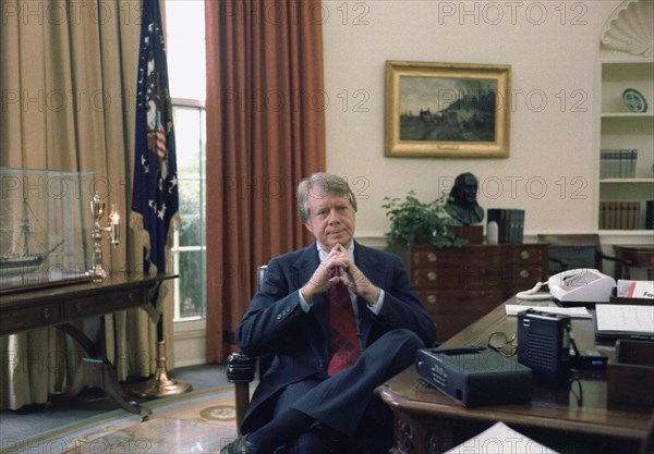 Jimmy Carter at his desk in the Oval Office