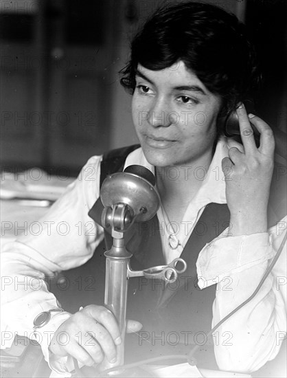 Early 1900s woman speaking on a telephone ca. 1913