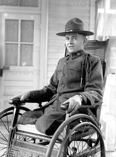 Soldier who lost his legs in World War I in his wheel chair ca. 1916