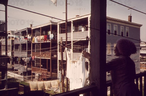 Woman Hangs Laundry at Her Home