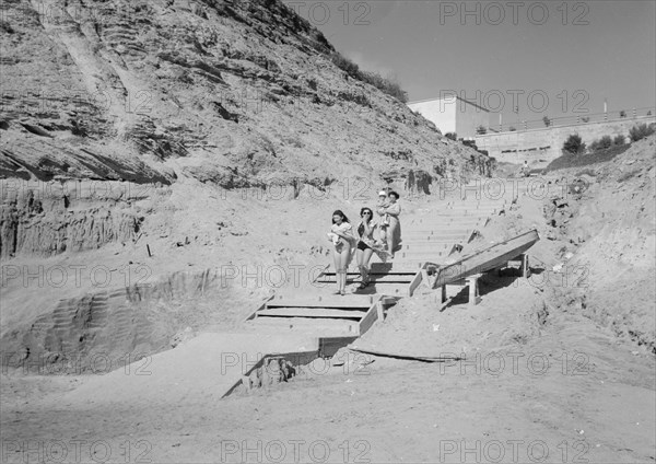 Women in swim suits walking to the beach in one of the Jewish coastal colonies, possibly Nathania ca. between 1934 and 1939