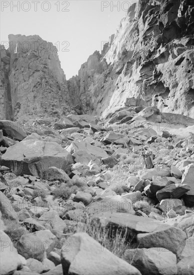 Man walking on the rocks of the ascent to Ras Safsaf by Jethro's Path. ca. 1900