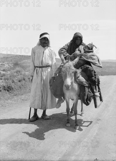 Bedouins in Israel, a woman and infant on donkey, a man standing ca. between 1934 and 1939
