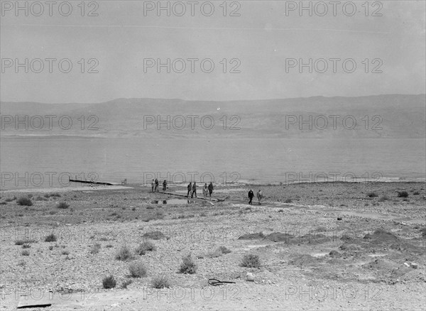 A group of people walking from the Dead Sea seen from the Kallia Hotel ca. between 1934 and 1939