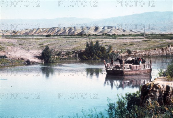 A ferry on the River Jordan, carrying horses ca. between 1950 and 1977
