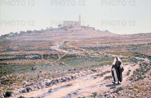 Man walking on road in an area near Jerusalem, possibly Mizpah (Neby Samwil) ca. between 1950 and 1977