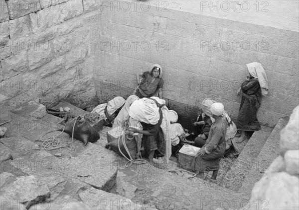 People drawing water from Ein el-Dirweh (Philips fountain) on Hebron road ca. between 1934 and 1939