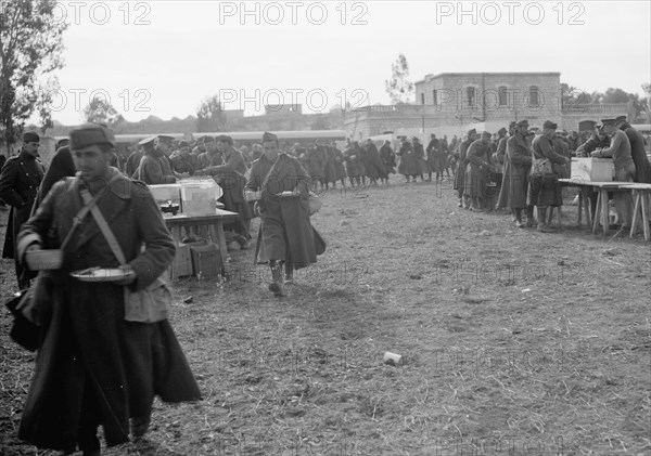 Italian prisoners eating food after detraining at Wady Sarar near the town of Qazaza in Palestine, Dec. 21st, 1940