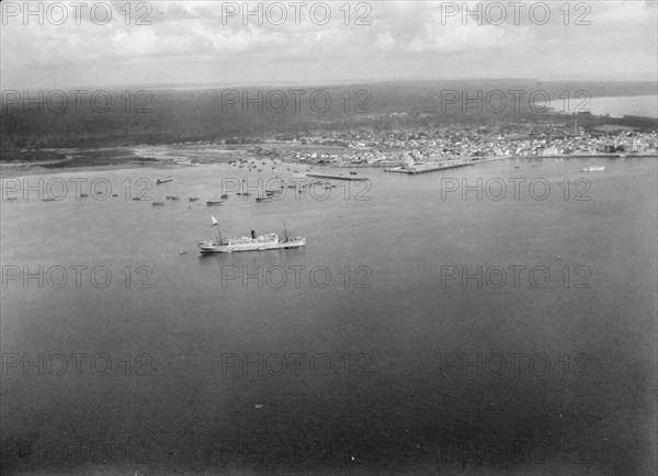 Aerial view of Zanzibar with the H.M.S. Pegasus seen in the port ca. 1936