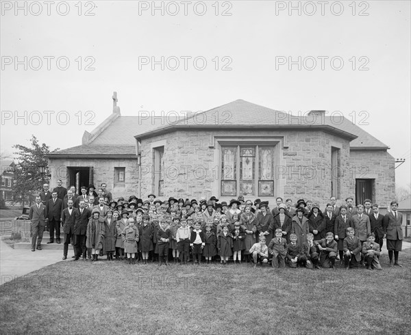 Group of children pose for a photo outside a Lutheran Church ca.  between 1910 and 1925
